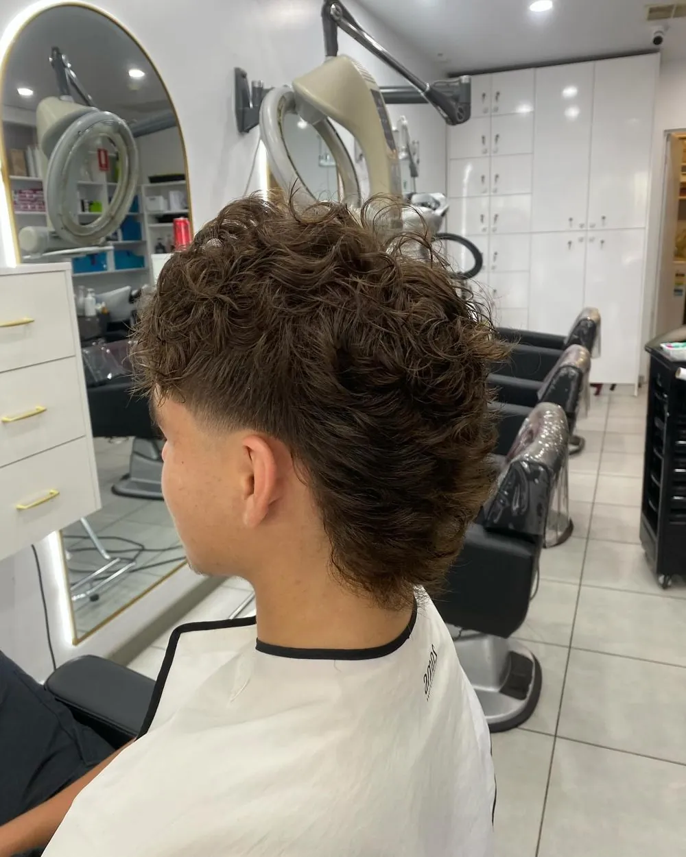 Curly textured perm on a client in the salon